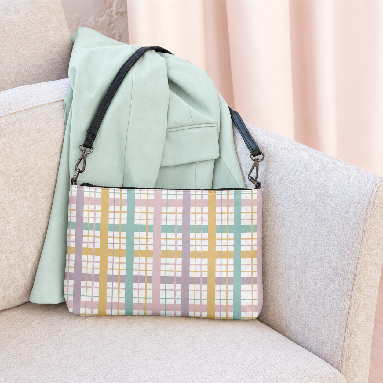 Pastel plaid crossbody bag on a cream armchair with a mint jacket